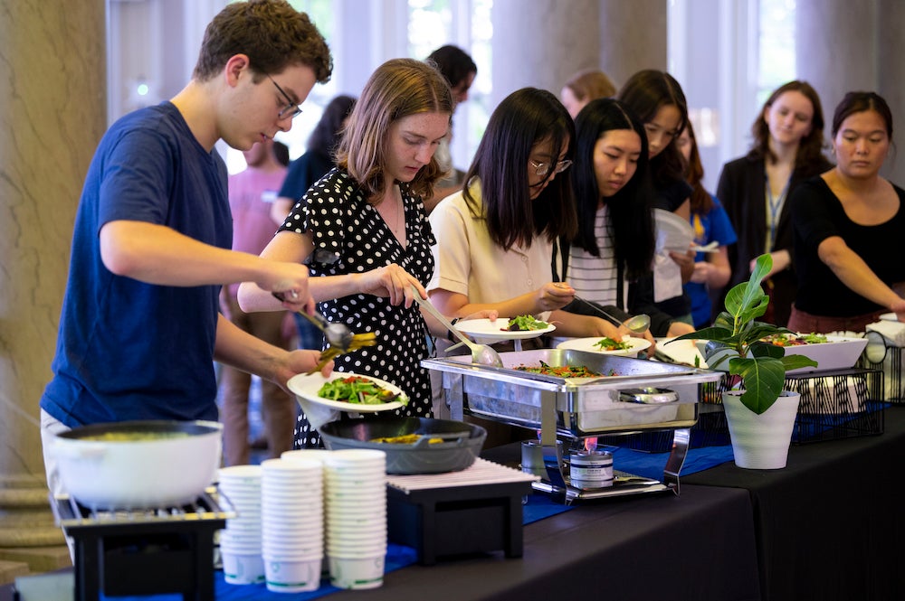 Students grab food at a carbon-tracked buffet for the 2022 Sustainability Supper hosted by the ScholarCHEF scholar community.